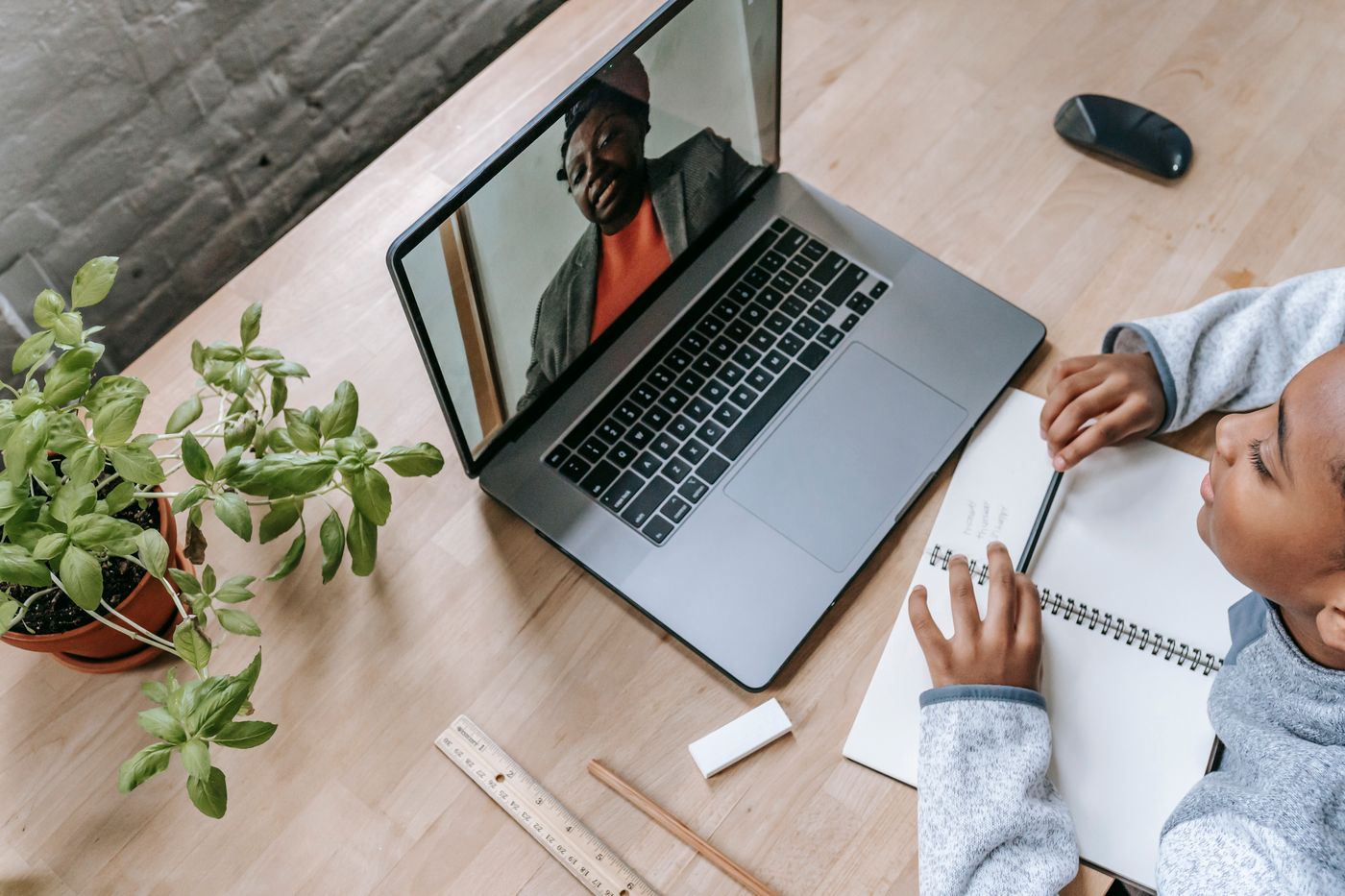 A student in an online video lesson with their tutor